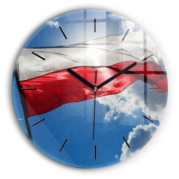 Orologio rotondo in vetro La bandiera polacca contro il cielo