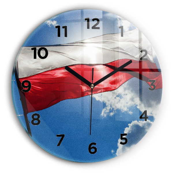 Orologio rotondo in vetro La bandiera polacca contro il cielo