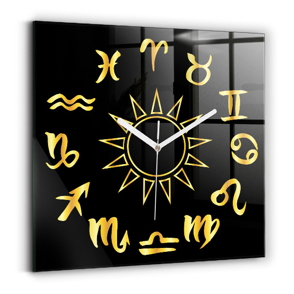 Orologio quadrato Segni zodiacali dorati su sfondo nero.